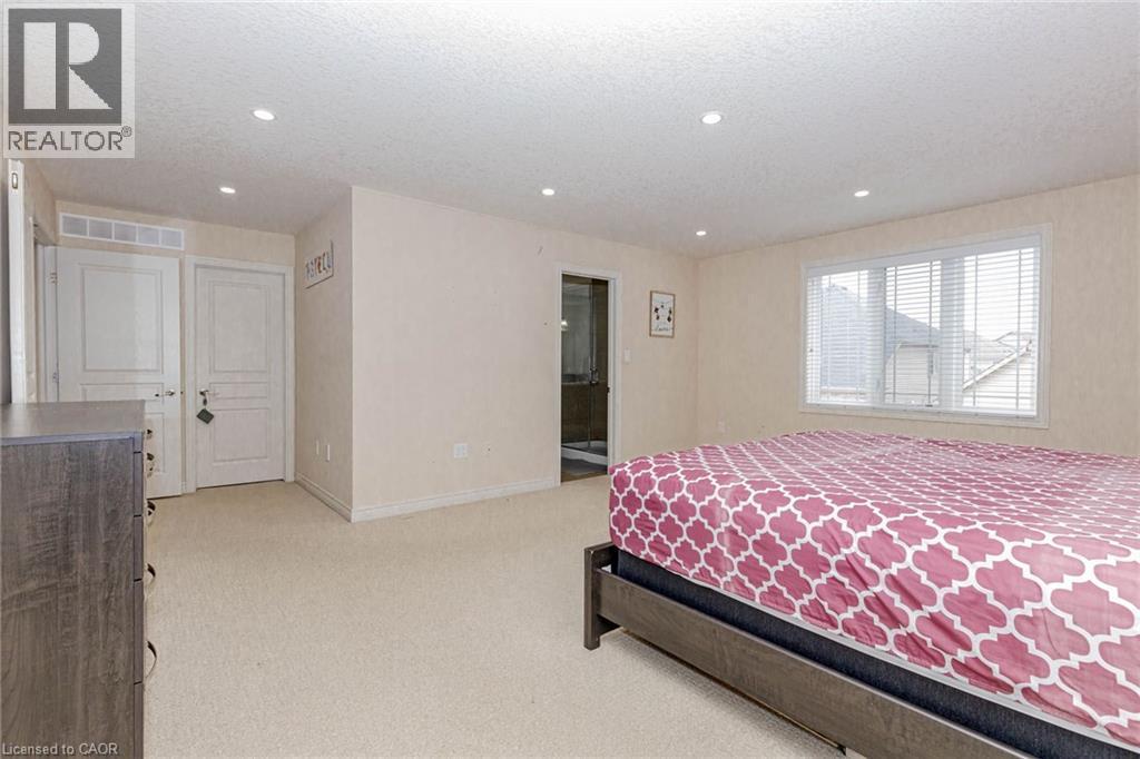 Bedroom with light carpet, a textured ceiling, recessed lighting, and connected bathroom - 2 Doon Creek Street, Kitchener, ON - Indoor Photo Showing Bedroom
