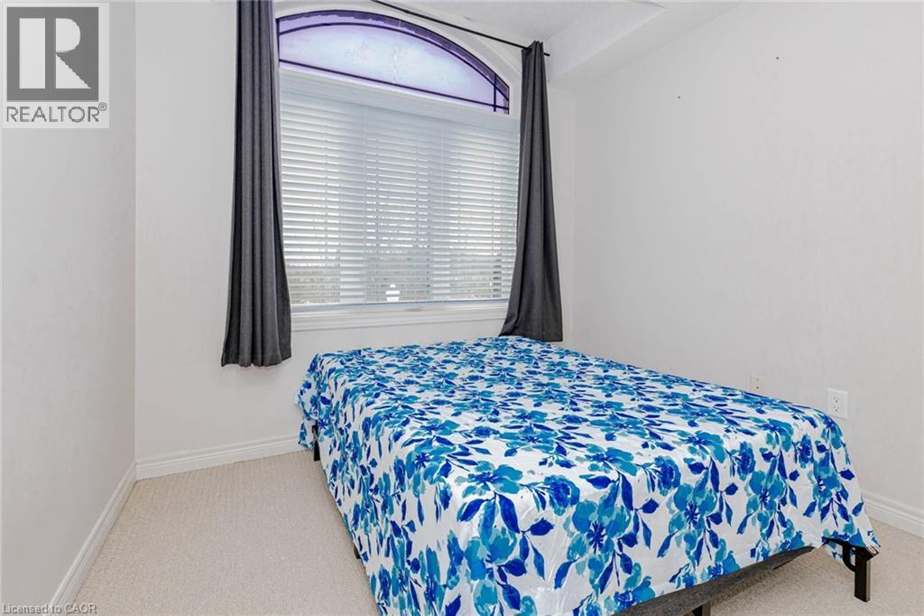 Bedroom with light colored carpet and multiple windows - 2 Doon Creek Street, Kitchener, ON - Indoor Photo Showing Bedroom