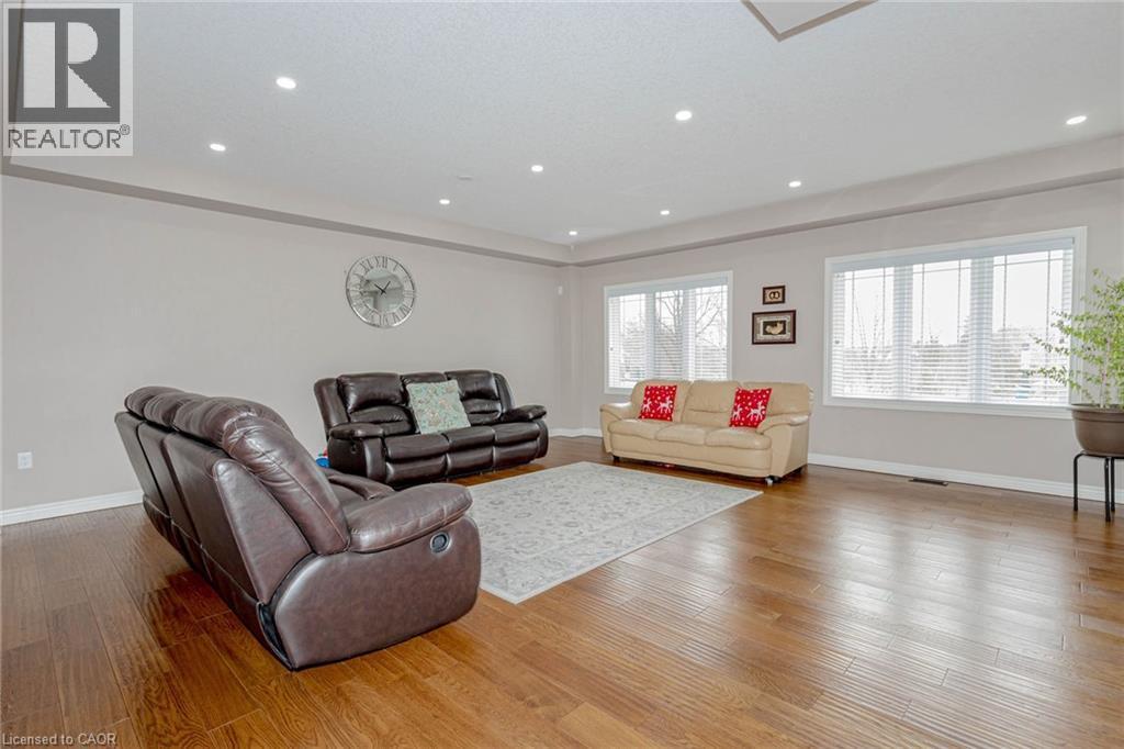 Living room with hardwood / wood-style flooring and recessed lighting - 2 Doon Creek Street, Kitchener, ON - Indoor Photo Showing Living Room