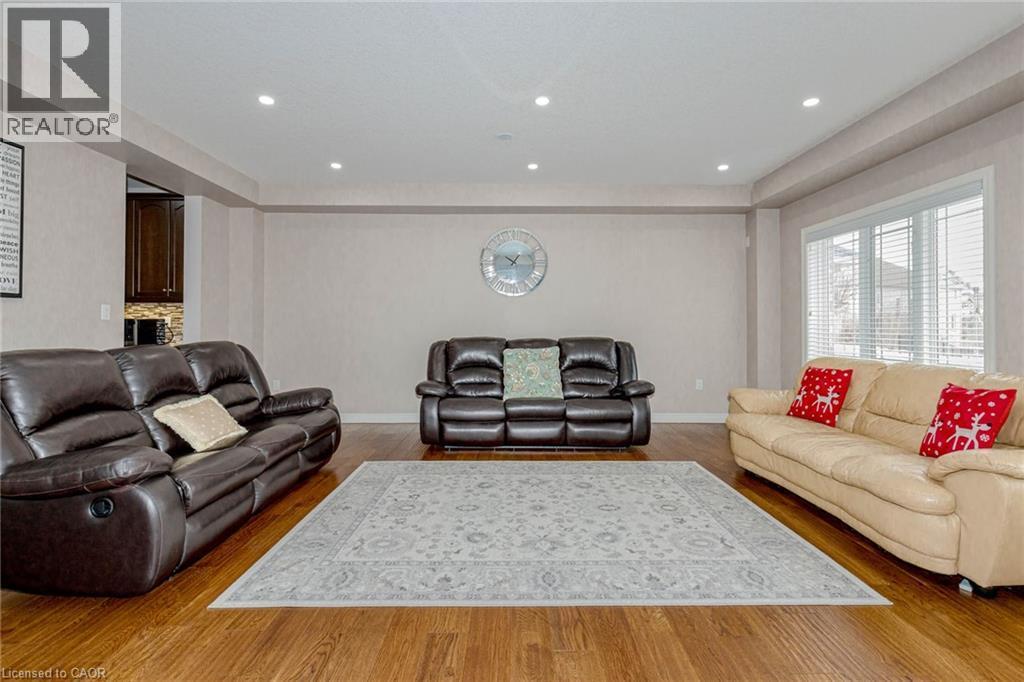 Living area with wood finished floors and recessed lighting - 2 Doon Creek Street, Kitchener, ON - Indoor Photo Showing Living Room