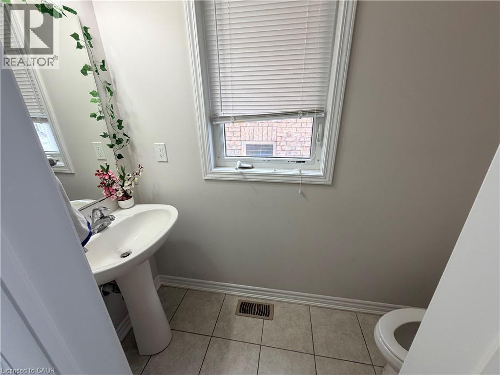 Bathroom featuring light tile patterned floors and toilet - 31 Sofitel Drive, Kitchener, ON - Indoor Photo Showing Bathroom