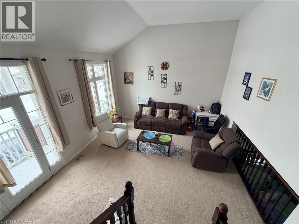 Living room with light carpet and lofted ceiling - 31 Sofitel Drive, Kitchener, ON - Indoor Photo Showing Living Room