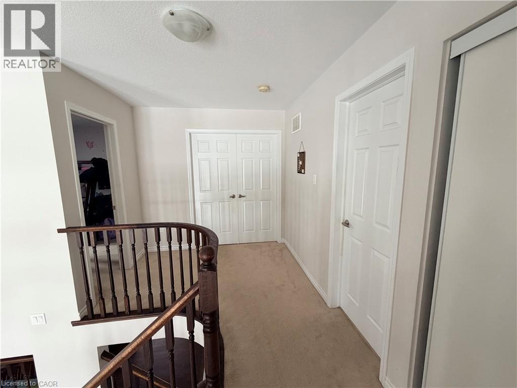Hall featuring an upstairs landing, light colored carpet, and a textured ceiling - 31 Sofitel Drive, Kitchener, ON - Indoor Photo Showing Other Room