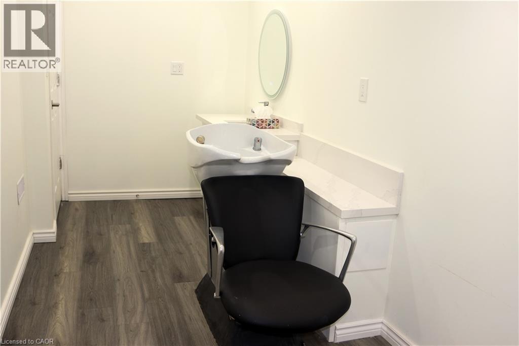 Half bathroom featuring dark wood-style floors and vanity - 31 Sofitel Drive, Kitchener, ON - Indoor