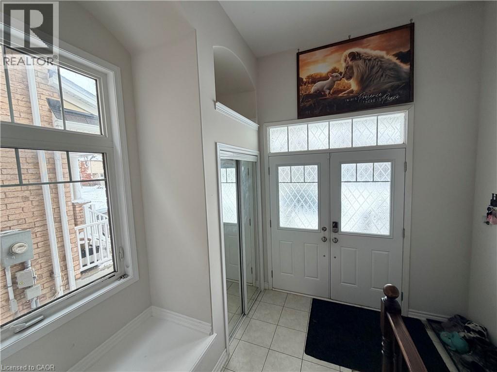 Foyer featuring light tile patterned flooring, healthy amount of natural light, and french doors - 31 Sofitel Drive, Kitchener, ON - Indoor Photo Showing Other Room