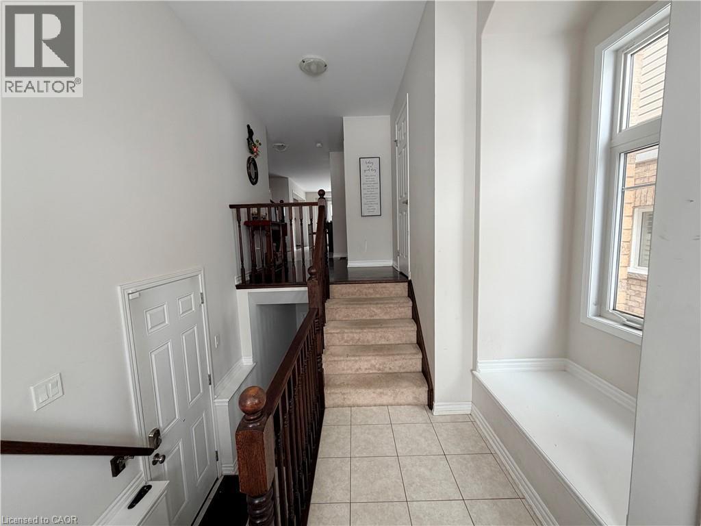 Staircase with tile patterned flooring and baseboards - 31 Sofitel Drive, Kitchener, ON - Indoor Photo Showing Other Room