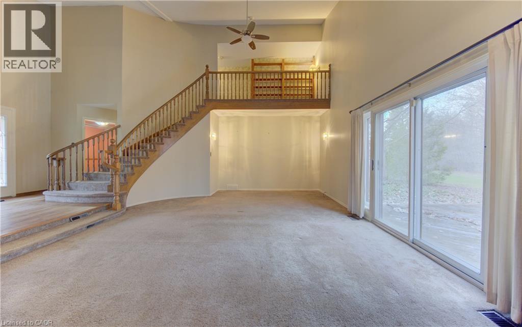 Unfurnished living room with ceiling fan, light colored carpet, and a high ceiling - 190 Silvercrest Drive, Waterloo, ON - Indoor Photo Showing Other Room