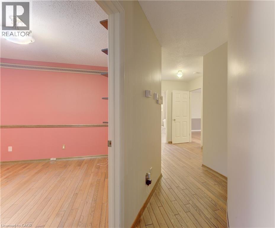 Hallway with light wood-style flooring and a textured ceiling - 190 Silvercrest Drive, Waterloo, ON - Indoor Photo Showing Other Room
