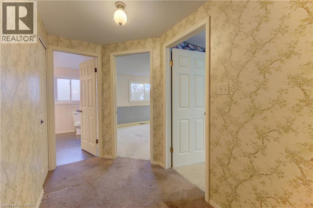 Corridor with a textured ceiling, plenty of natural light, and light carpet - 190 Silvercrest Drive, Waterloo, ON - Indoor Photo Showing Other Room