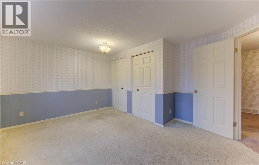 Unfurnished bedroom with carpet, two closets, and a textured ceiling - 190 Silvercrest Drive, Waterloo, ON - Indoor Photo Showing Other Room