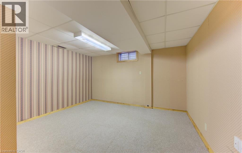 Finished below grade area featuring a paneled ceiling, carpet, and wallpapered walls - 190 Silvercrest Drive, Waterloo, ON - Indoor Photo Showing Basement