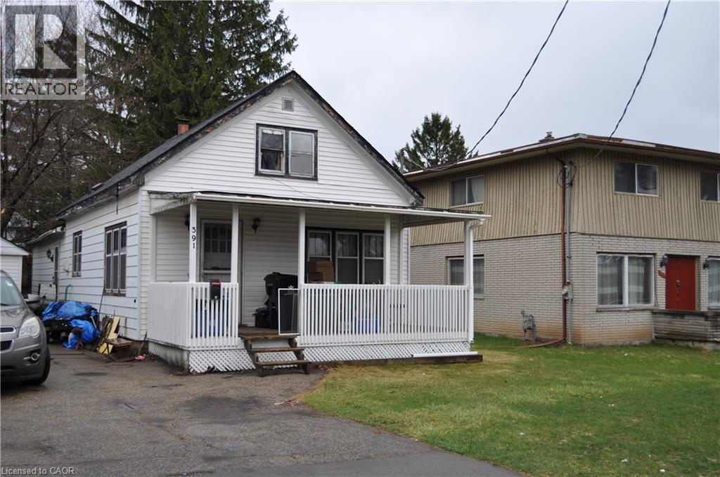 View of front of house with aluminium siding, a porch, and a front yard - 391 Lawrence Avenue, Kitchener, ON - Outdoor