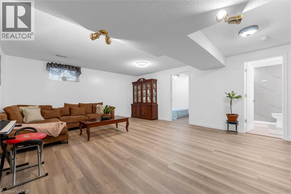 Living room with light wood-style floors and a textured ceiling - 51 Independence Drive, Hamilton, ON - Indoor