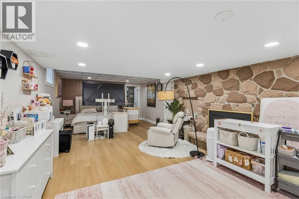 Living area with light wood-type flooring and recessed lighting - 3 Chicopee Terrace, Kitchener, ON - Indoor With Fireplace