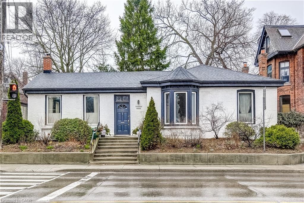 View of front of home featuring a chimney, brick siding, and roof with shingles - 315 Aberdeen Avenue, Hamilton, ON - Outdoor