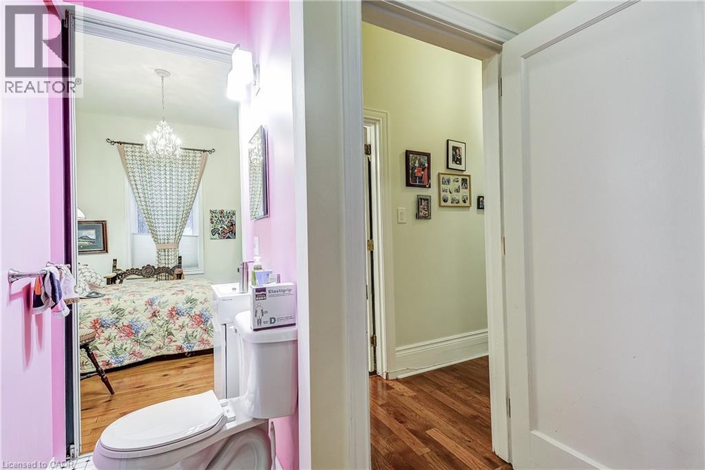 Bathroom with wood finished floors, suspended lighting, and ensuite bath - 315 Aberdeen Avenue, Hamilton, ON - Indoor Photo Showing Bathroom