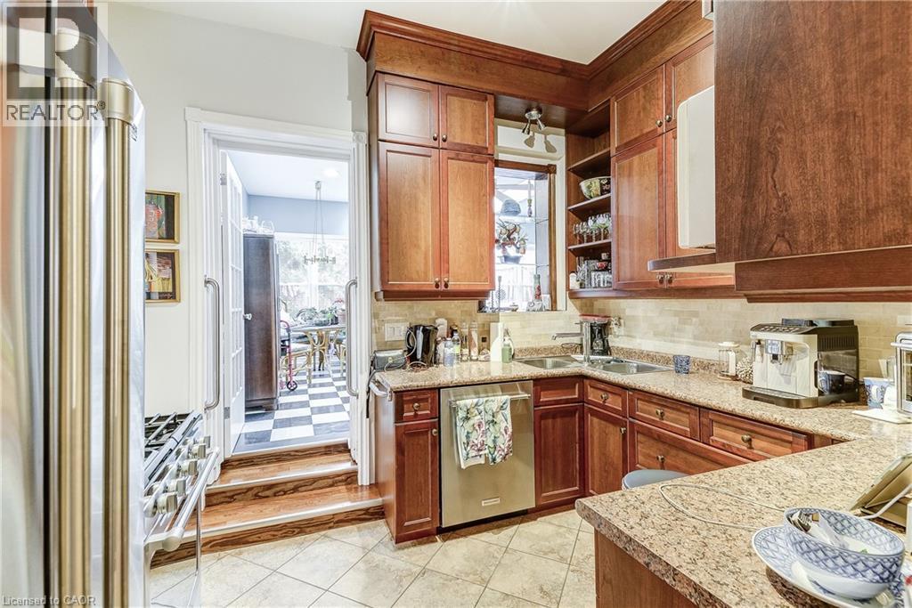 Kitchen featuring high quality appliances, open shelves, wood finish cabinetry, decorative backsplash, and light tile patterned floors - 315 Aberdeen Avenue, Hamilton, ON - Indoor Photo Showing Kitchen