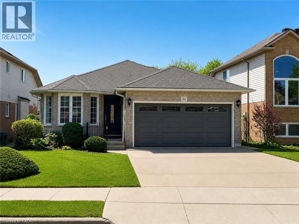 Brick facade residence featuring a two-car garage, a concrete driveway, and a shingle roof - 51 Redtail Crescent, Hamilton, ON - Outdoor With Facade