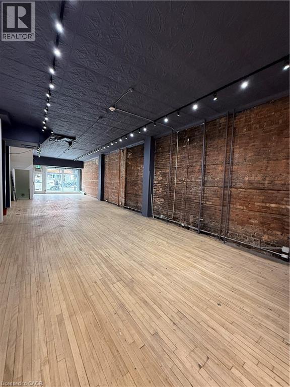 Retail Space with track lighting and brick wall - 228 James Street N, Hamilton, ON