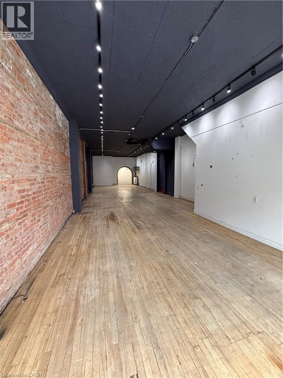 Retail Space with rail lighting and brick wall - 228 James Street N, Hamilton, ON