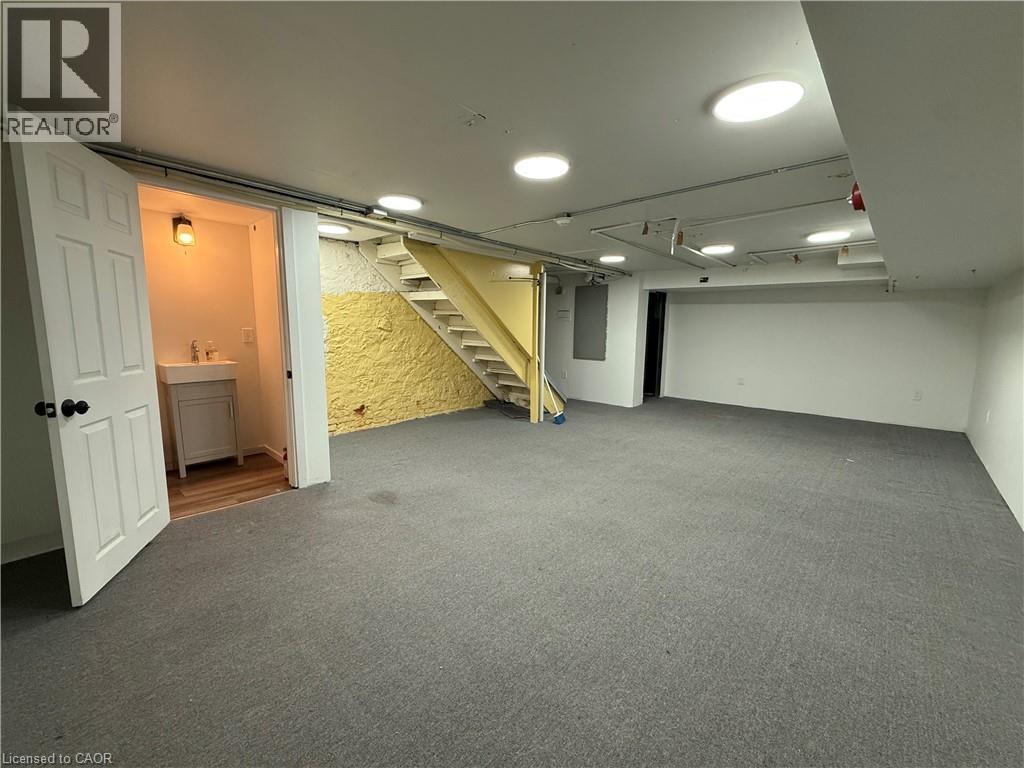 Finished basement featuring carpet and 2 Pc Washroom - 228 James Street N, Hamilton, ON