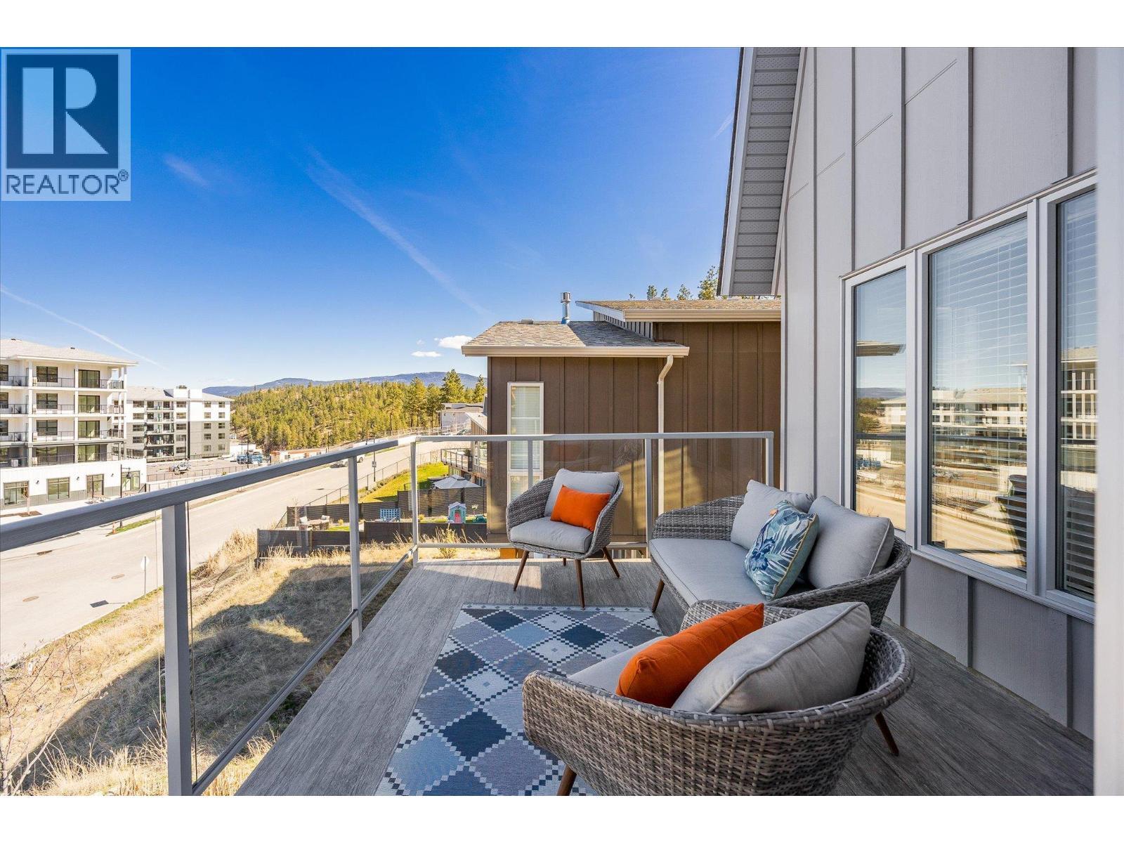 Patio off of the main living area provides a great location to watch the sunset or enjoy a bbq with friends - 1860 Blue Bunch Court, Kelowna, BC - Outdoor With Exterior