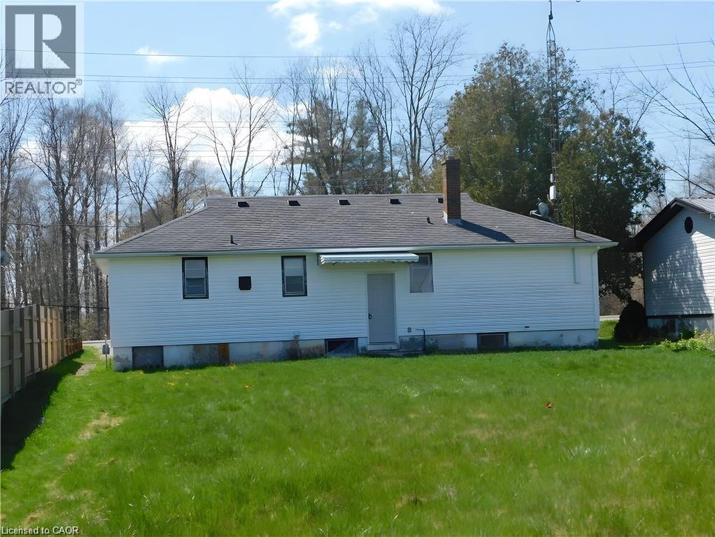 Rear view of house with a chimney and a shingled roof - 2474 Highway 24, Simcoe, ON