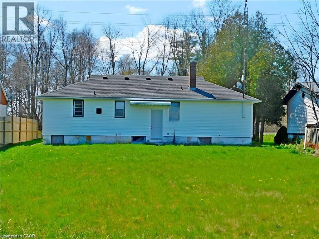 Rear view of property with a chimney and a shingled roof - 2474 Highway 24, Simcoe, ON