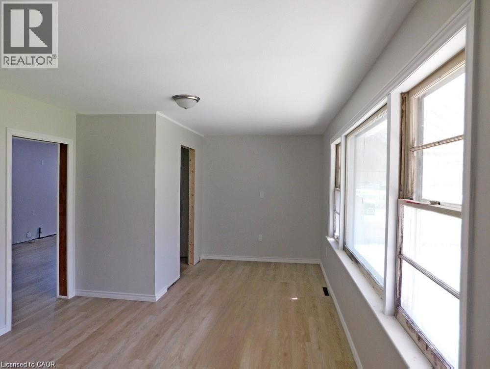 Spare room with light wood-style floors and baseboards - 2474 Highway 24, Simcoe, ON