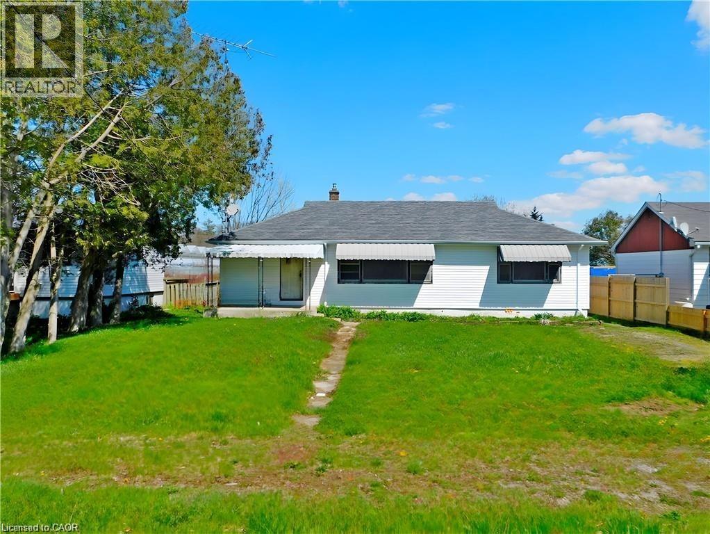 Rear view of house with a chimney and covered porch - 2474 Highway 24, Simcoe, ON