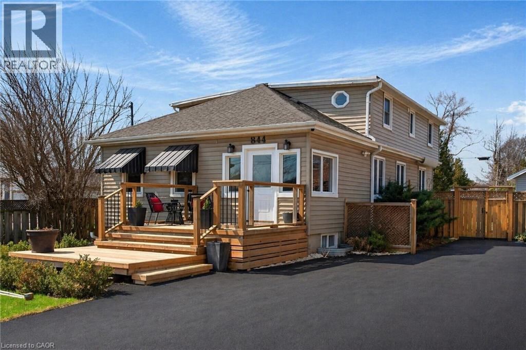 Two-story residence featuring light-colored siding and a dark shingled roof - 844 Upper Wellington Street, Hamilton, ON - Outdoor