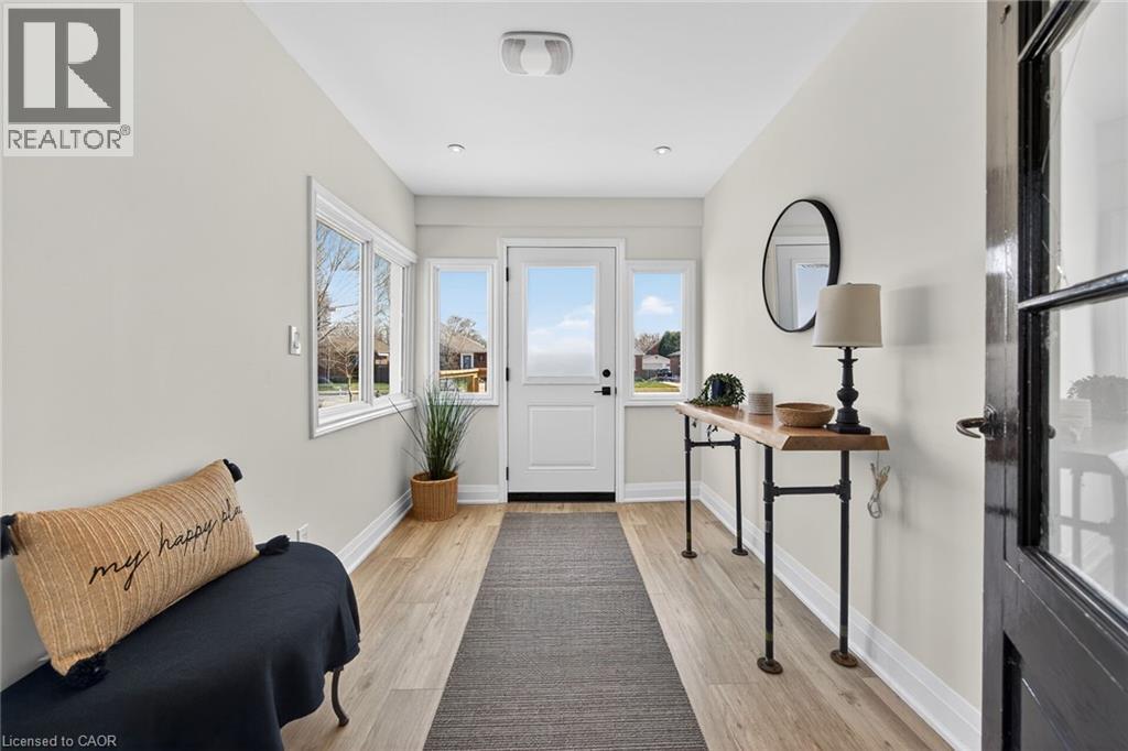 View of front of home with a shingled roof and a wooden deck - 844 Upper Wellington Street, Hamilton, ON - Outdoor