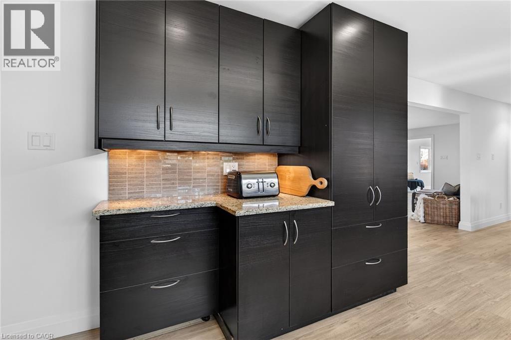Kitchen view of dark stone counters and stainless steel dishwasher - 844 Upper Wellington Street, Hamilton, ON - Indoor Photo Showing Kitchen With Double Sink