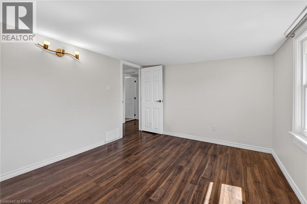 Unfurnished room featuring dark wood finished floors and baseboards - 844 Upper Wellington Street, Hamilton, ON - Indoor Photo Showing Other Room