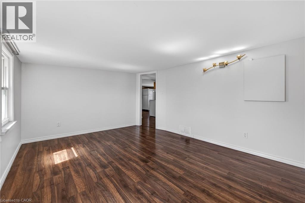 Unfurnished room with dark wood-type flooring and baseboards - 844 Upper Wellington Street, Hamilton, ON - Indoor Photo Showing Other Room