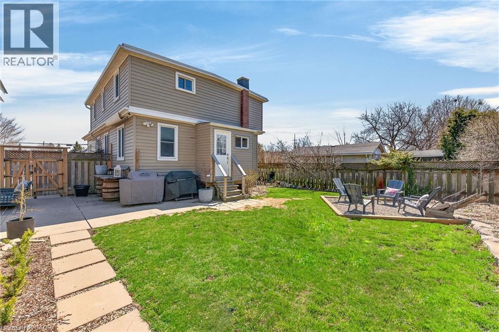 Rear view of property with a patio area, a fire pit, a shed, a chimney, and entry steps - 844 Upper Wellington Street, Hamilton, ON - Outdoor