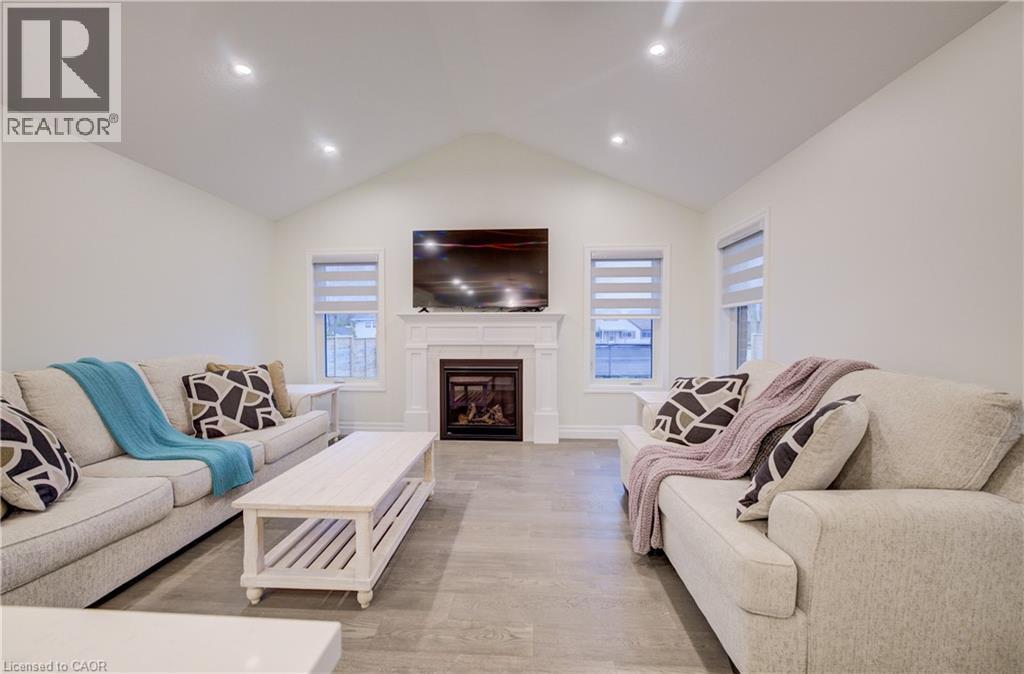 Cathedral Ceiling and LED Pot Lights - 4 Livingston Drive, Tillsonburg, ON - Indoor Photo Showing Living Room With Fireplace