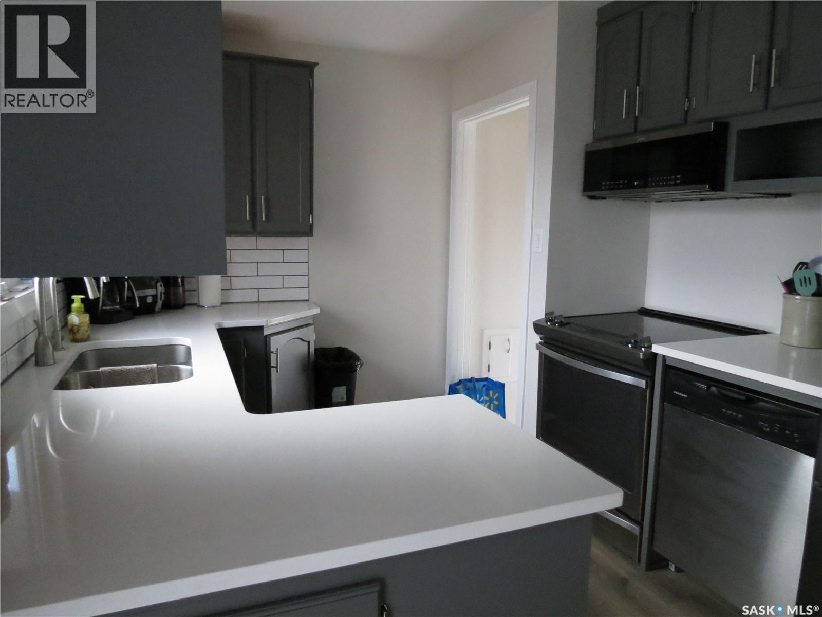 19 Merlin Crescent, Regina, SK - Indoor Photo Showing Kitchen With Double Sink