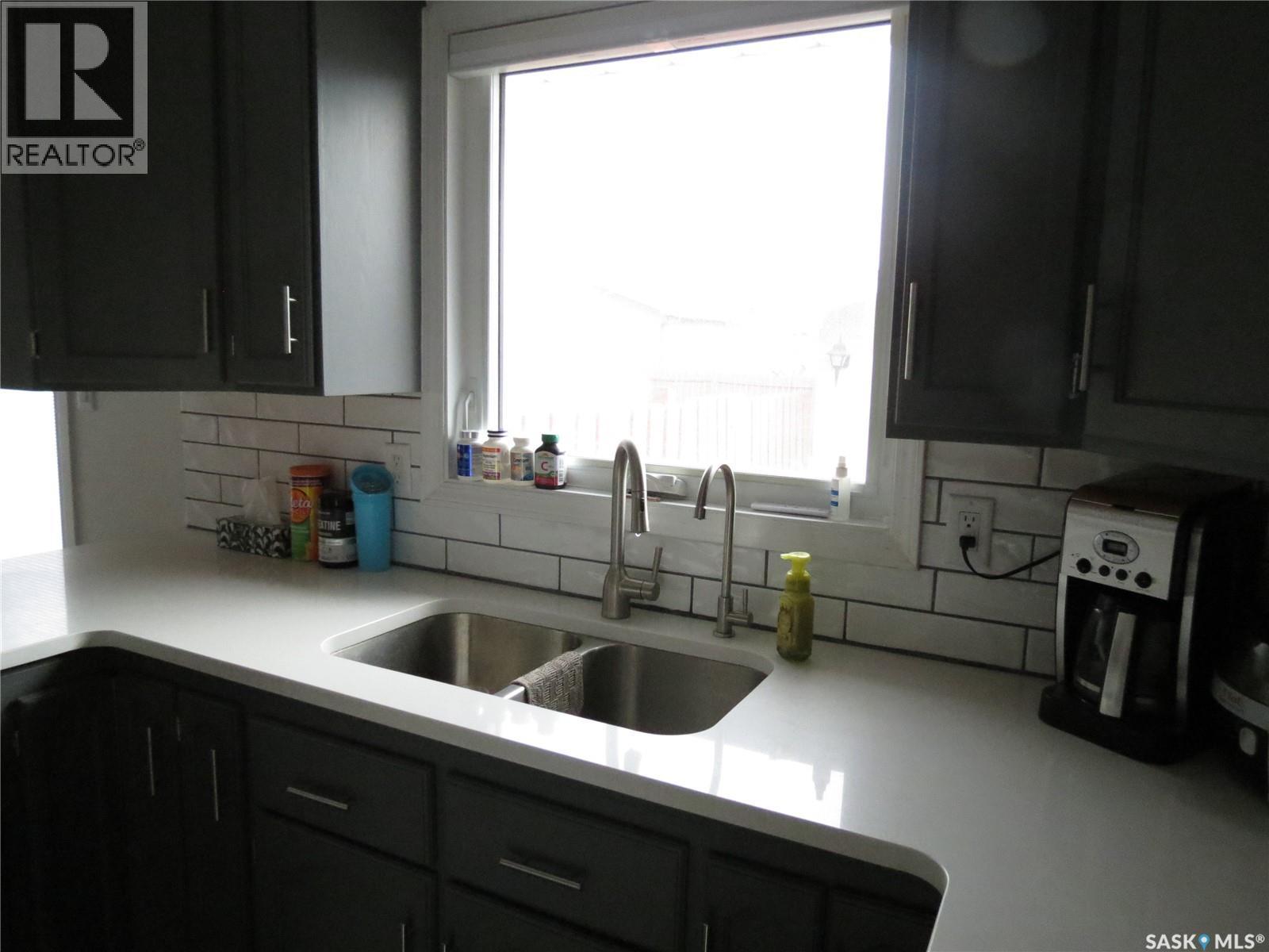 19 Merlin Crescent, Regina, SK - Indoor Photo Showing Kitchen With Double Sink