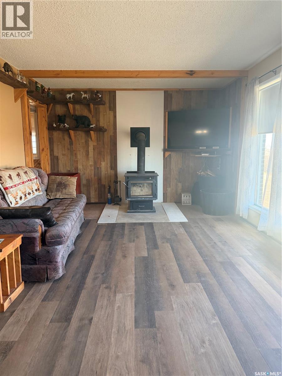 Mezzo Acreage Grid Road, Tompkins, SK - Indoor Photo Showing Living Room With Fireplace