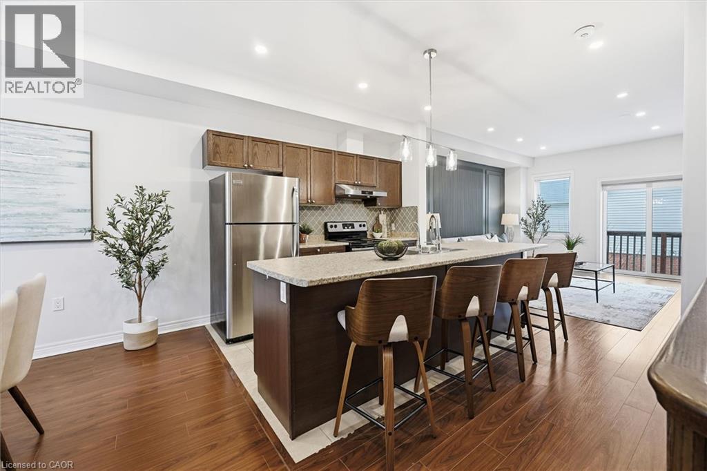 Kitchen island breakfast bar perfect for entertaining. - 122 E Dundas Street E Unit# 9, Waterdown, ON - Indoor Photo Showing Kitchen With Upgraded Kitchen
