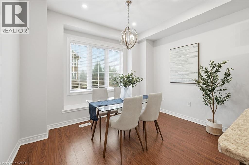 Dining area featuring wood flooring and pot lights - 122 E Dundas Street E Unit# 9, Waterdown, ON - Indoor Photo Showing Dining Room