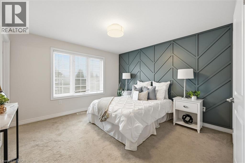 Primary bedroom with feature accent wall. - 122 E Dundas Street E Unit# 9, Waterdown, ON - Indoor Photo Showing Bedroom