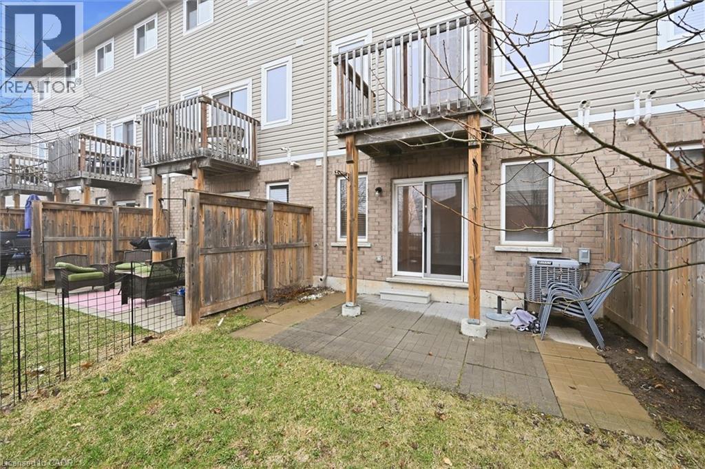 Back of house with a fenced backyard, a patio, a balcony. - 122 E Dundas Street E Unit# 9, Waterdown, ON - Outdoor