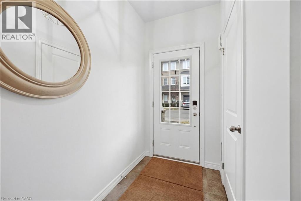 Welcoming foyer with electronic door lock, ceramic tile and convenient front entry closet. - 122 E Dundas Street E Unit# 9, Waterdown, ON - Indoor Photo Showing Other Room