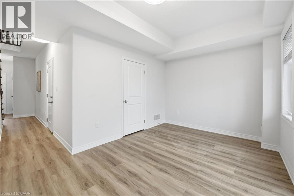 New light wood laminate floors, raised ceiling. - 122 E Dundas Street E Unit# 9, Waterdown, ON - Indoor Photo Showing Other Room