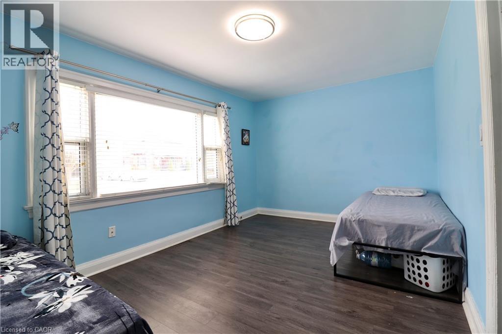 Unfurnished bedroom with dark wood-style floors and baseboards - 80 Roseview Avenue, Cambridge, ON - Indoor Photo Showing Bedroom