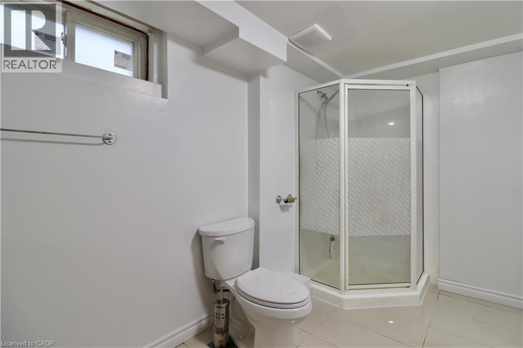 Bathroom with a shower stall and light tile patterned floors - 80 Roseview Avenue, Cambridge, ON - Indoor Photo Showing Bathroom
