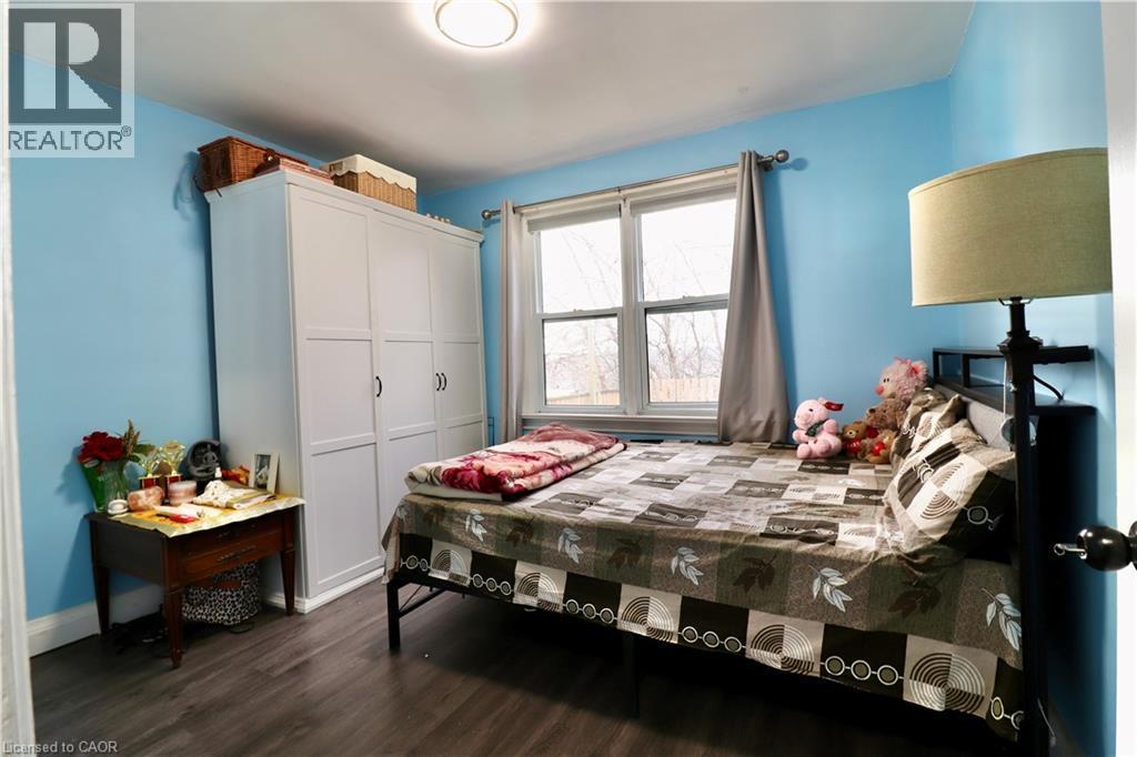 Bedroom with a closet and dark wood-style floors - 80 Roseview Avenue, Cambridge, ON - Indoor Photo Showing Bedroom