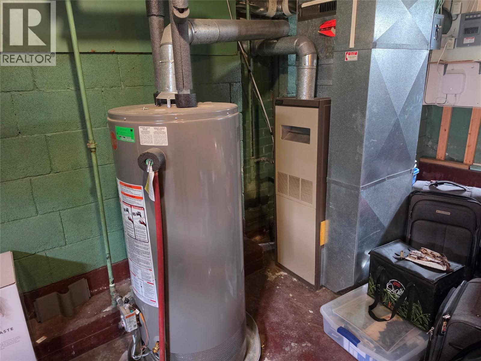 Gas furnace and hot water tank - 804 Eighth Street, Nelson, BC - Indoor Photo Showing Basement